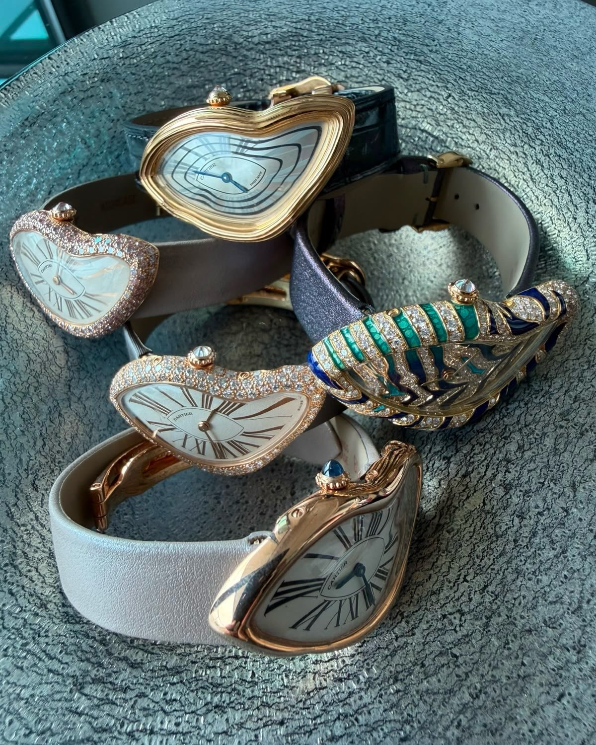 Five pink and yellow gold Cartier Crash watches, several set with diamonds, and a Crash with an enamel tiger-stripe case