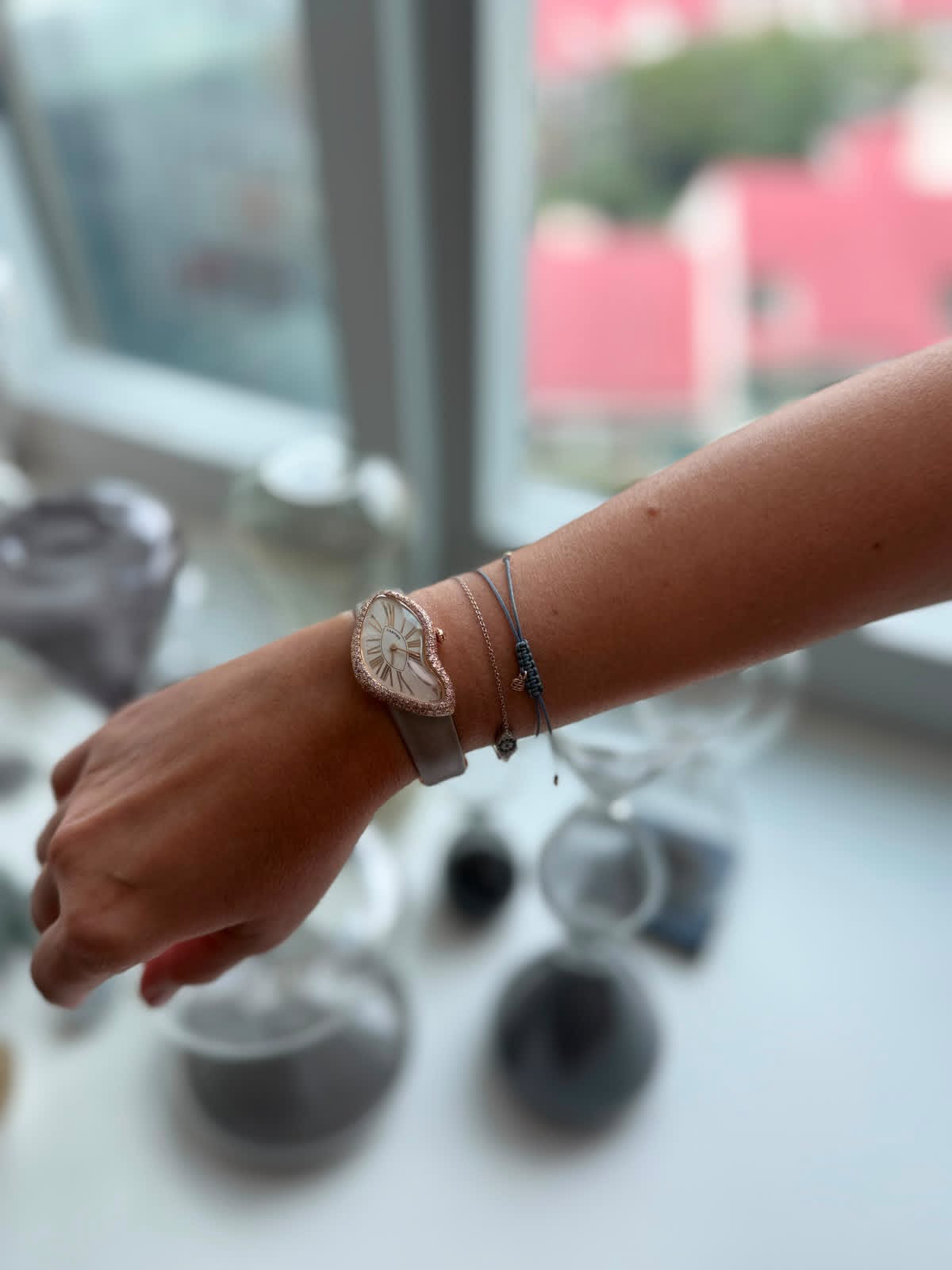 Fiona Bartholomeusz wearing her pink gold Cartier Crash Ref. 2463 with a pink diamond pavé case on a grey strap