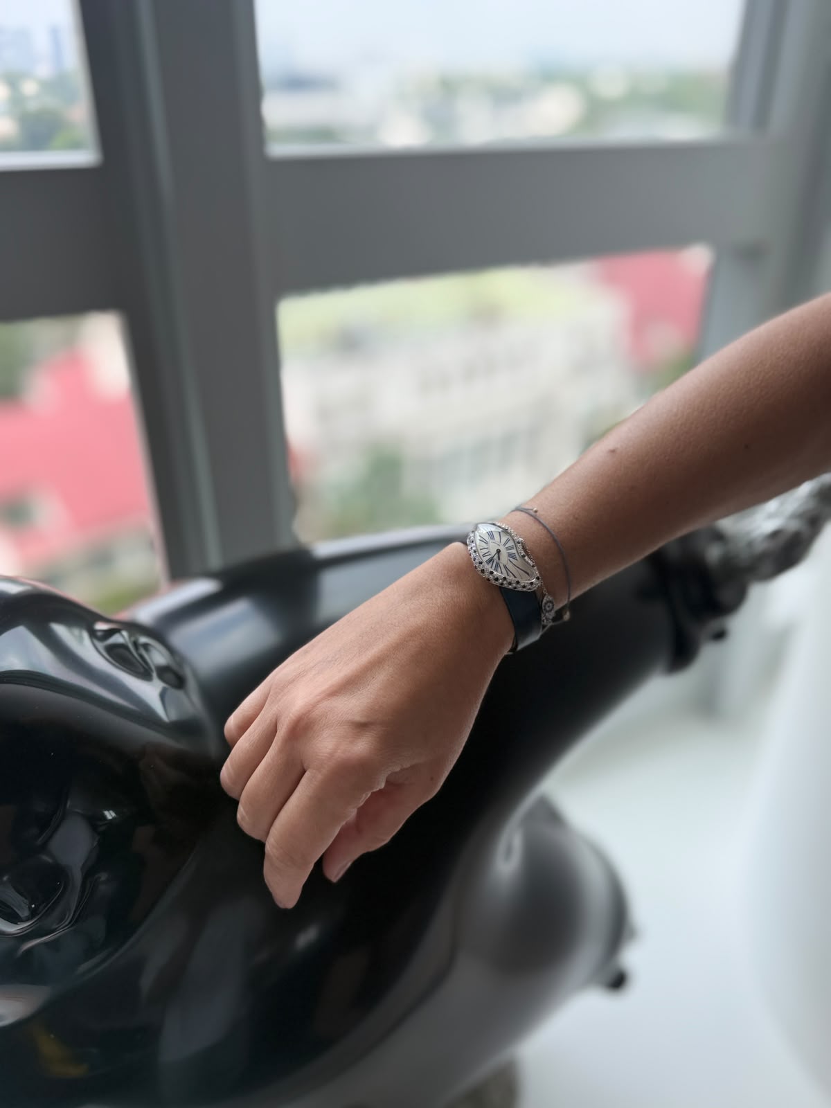 Cartier Crash with a white gold bezel spotted with blue sapphires, worn on the wrist