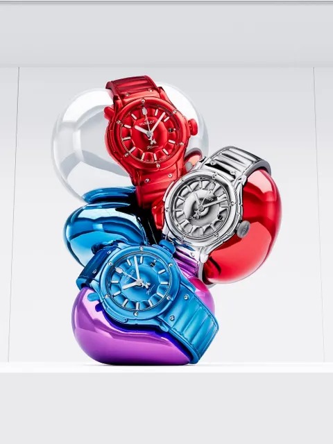 Red, silver and blue, staged inside Koons-style balloon sculpture forms