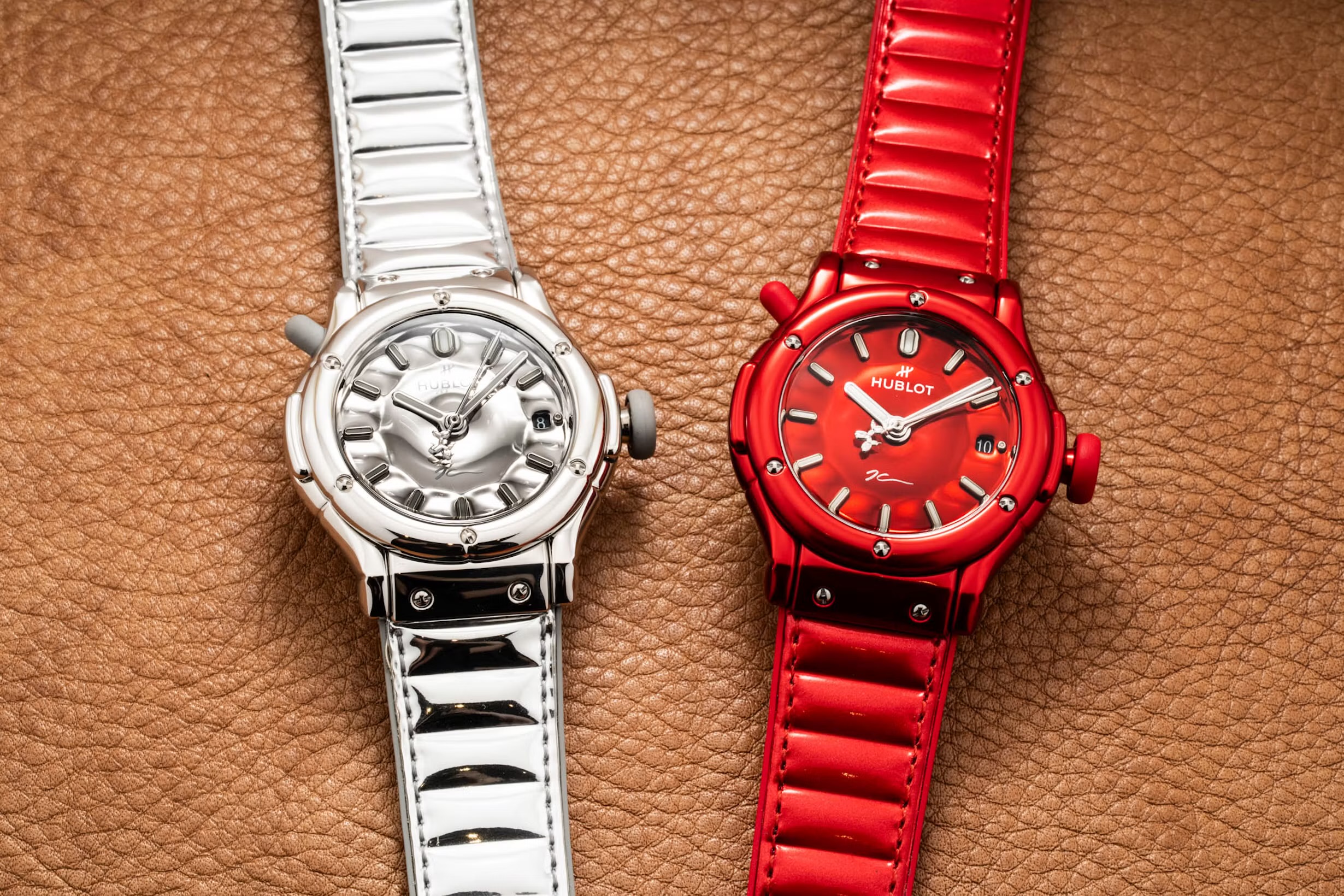 Mirror-polished steel and red editions side by side