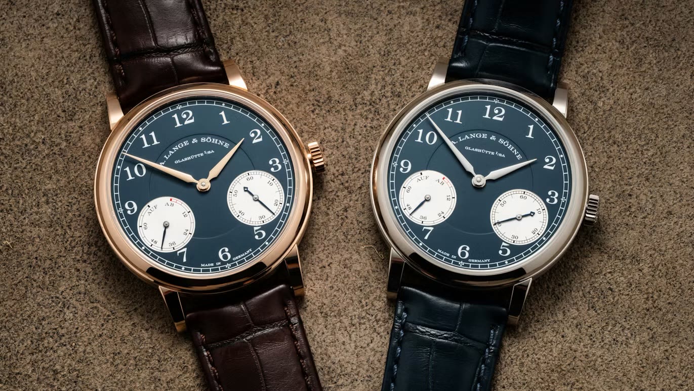 A. Lange & Söhne 1815 Up/Down in pink gold and white gold, flat lay on textured surface