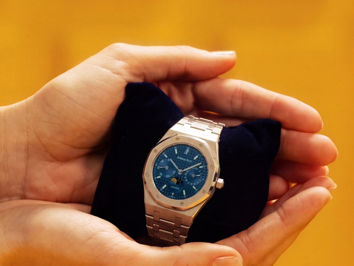 Pre-owned Audemars Piguet Royal Oak with blue dial held in a pouch